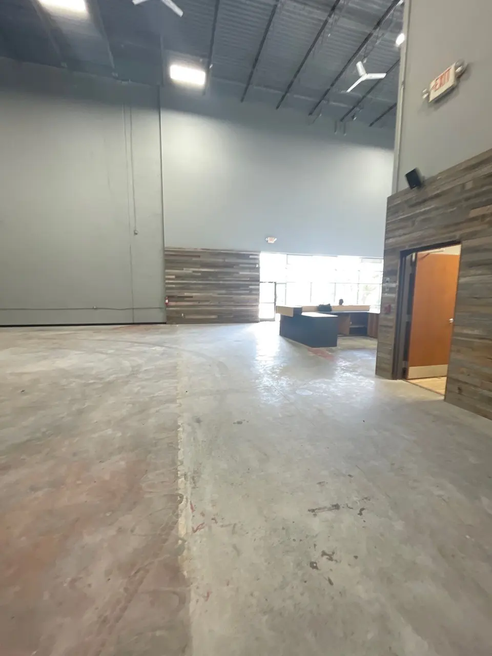 The tenant space before work started: bare slab, exposed deck and unfinished walls