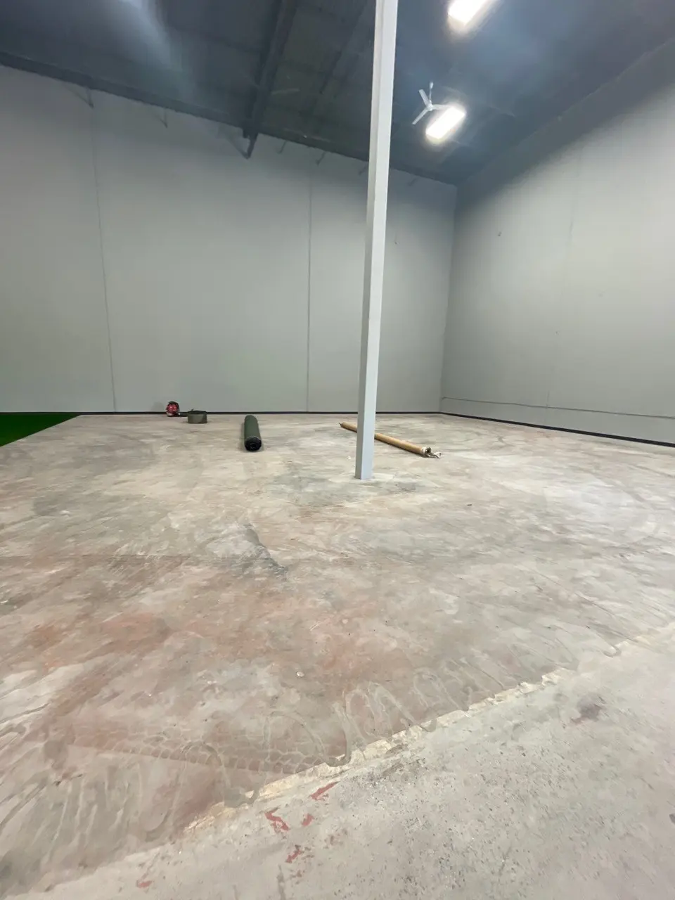 The tenant space before work started: bare slab, exposed deck and unfinished walls