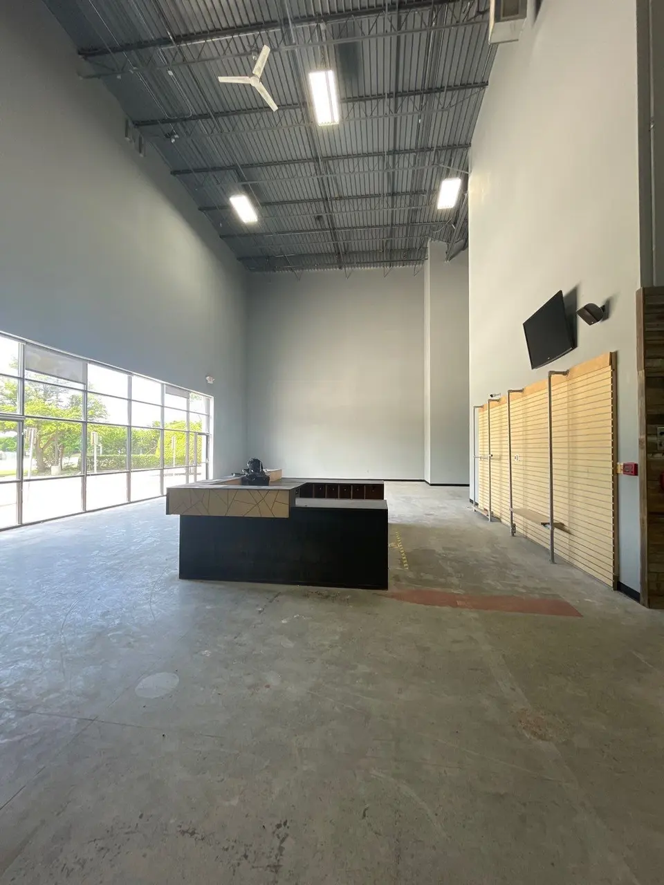 The tenant space before work started: bare slab, exposed deck and unfinished walls